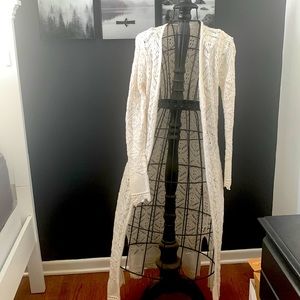 White crocheted duster sweater . Washed to wear but never worn . No tags